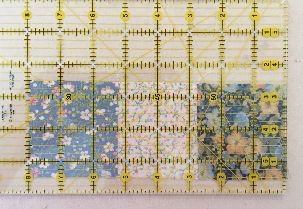 measuring three squares stitched together with a 1/4" seam allowance.