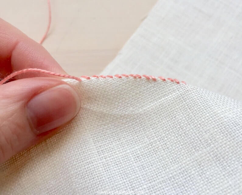 overcast stitch on a crease in white fabric.
