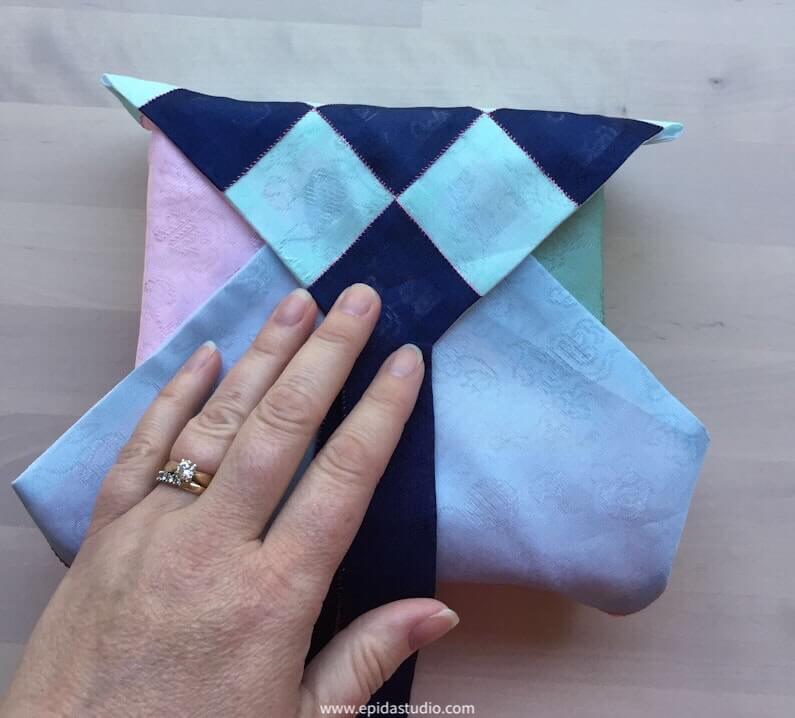 pojagi with all sides folded around an item.