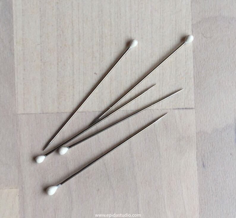 pins scattered on table.