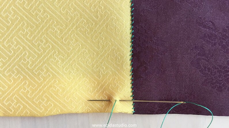 backstitch on yellow silk