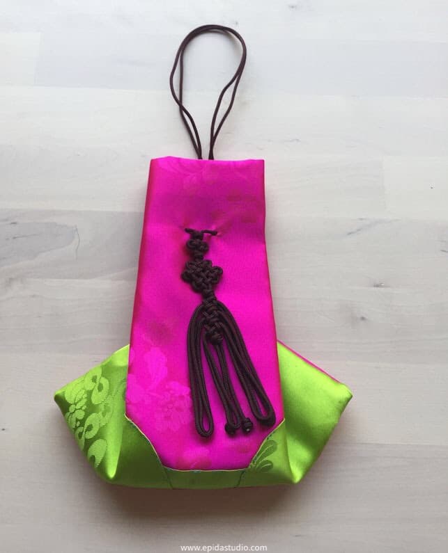 pink and green silk bag with tie.