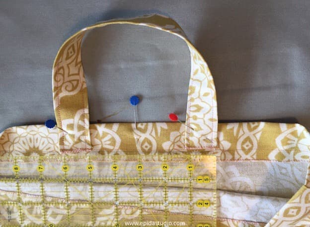 measuring the bag to centre the handle.