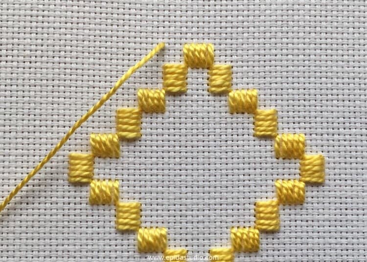 hardanger embroidery with yellow perle cotton on white aida cloth.