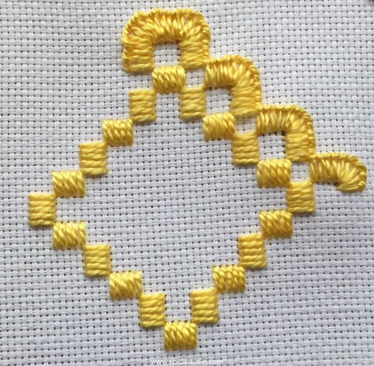 hardanger embroidery with yellow perle cotton on white aida cloth.