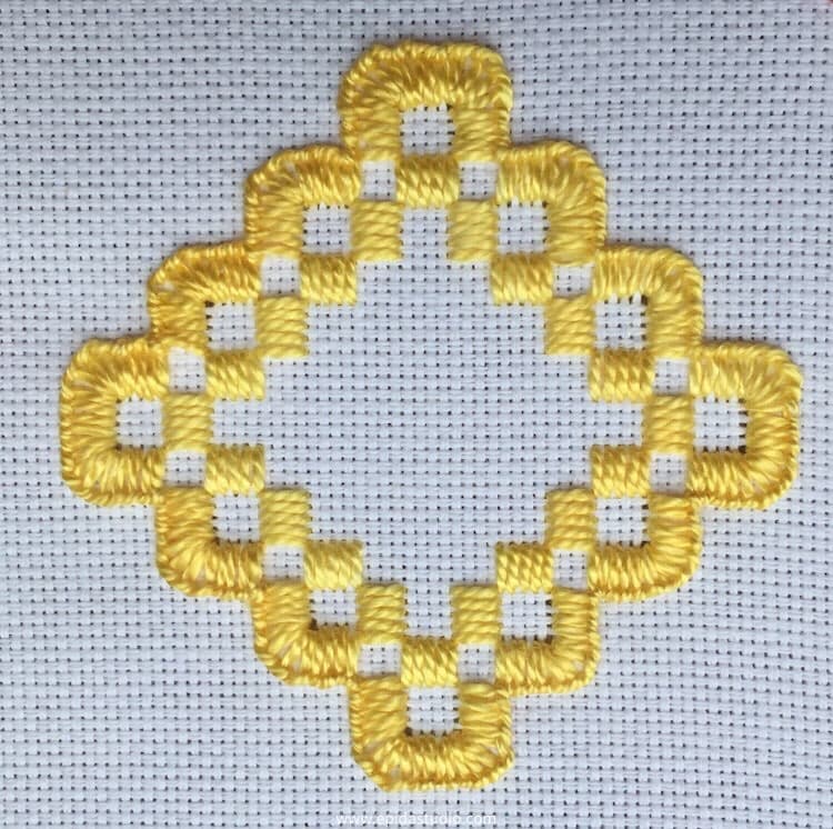 embroidered diamond made with kloster blocks and blanket stitch in yellow perle cotton.