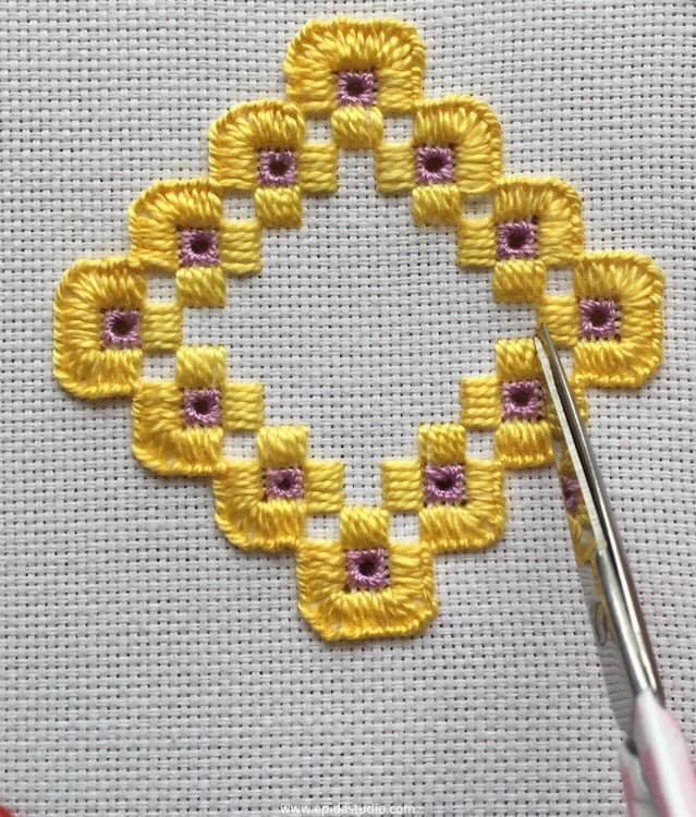 cutting away threads for hardanger embroidery.