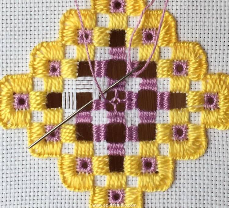 transitioning from dove's eye to weaving bars in hardanger embroidery.