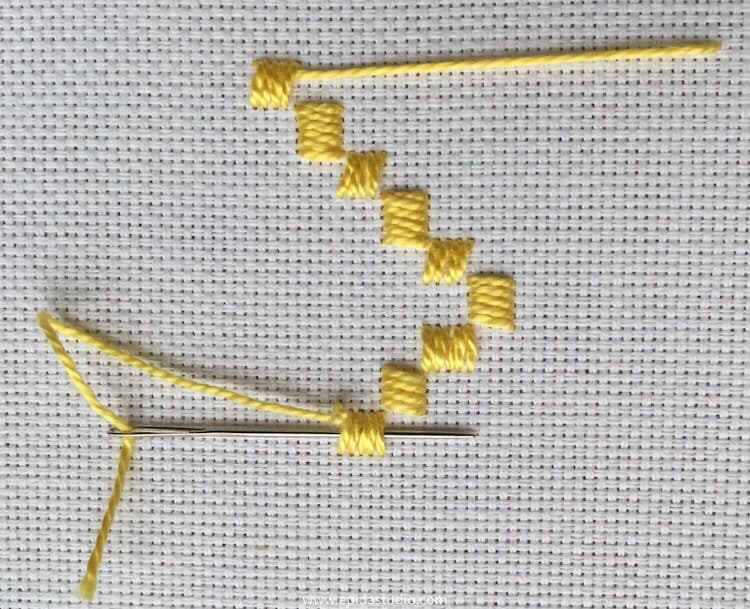 weaving in the thread end in embroidery.