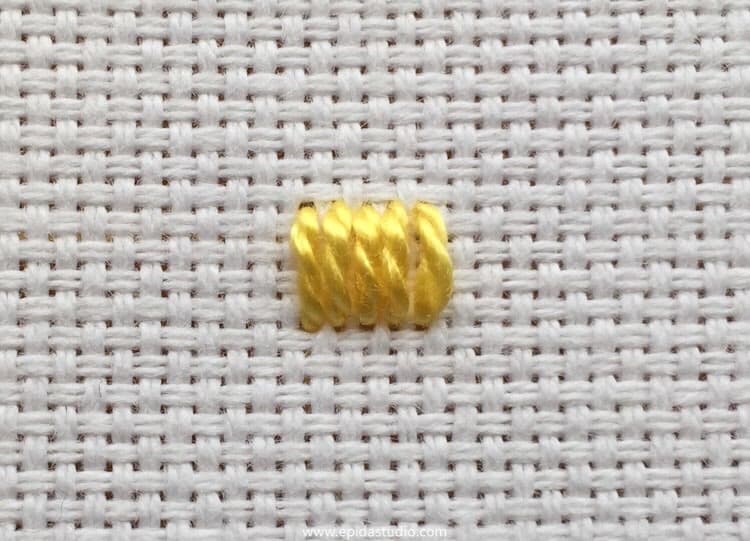 single kloster block embroidered with yellow thread.