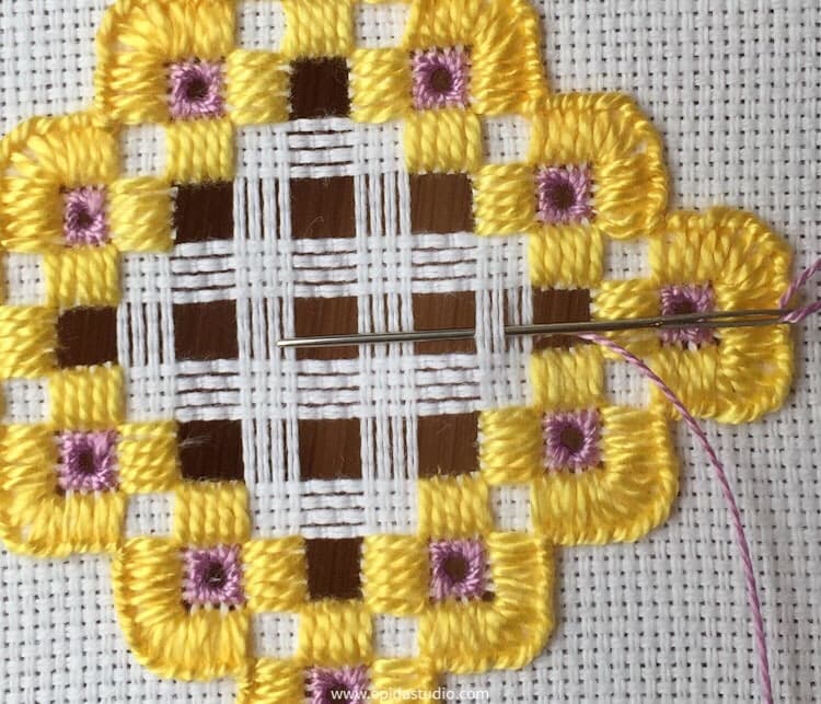 weaving thread bars with purple thread.