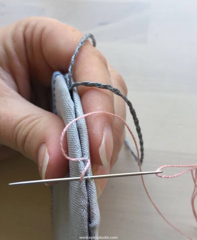 stitching two pieces together with cross stitch.