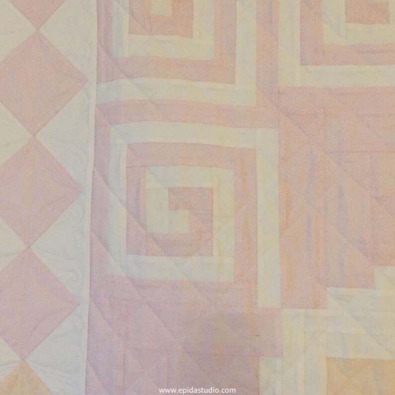close up of pink and white Greek Key block in a quilt.
