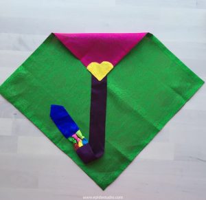 traditional pojagi wrapping cloth in pink and green with a long blue tie.