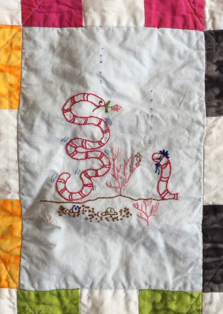 quilt block with embroidered sea snake