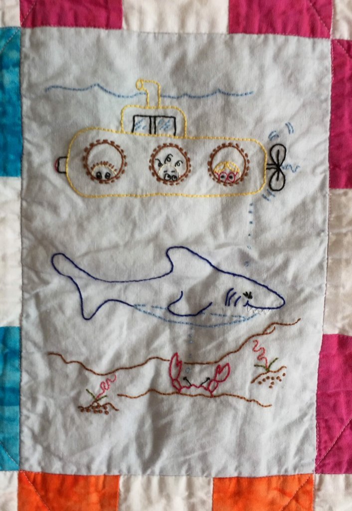 embroidered quilt block with shark and yellow submarine