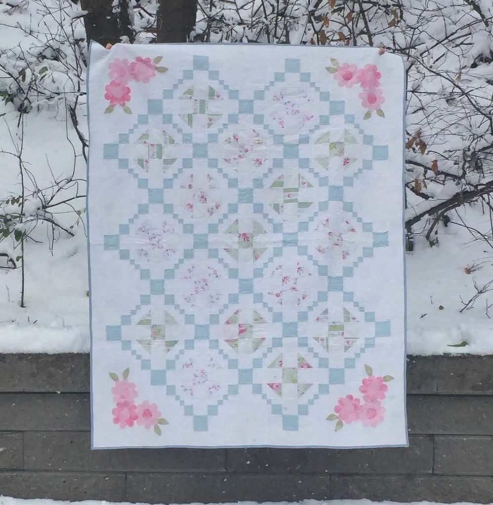 white, blue and pink quilt