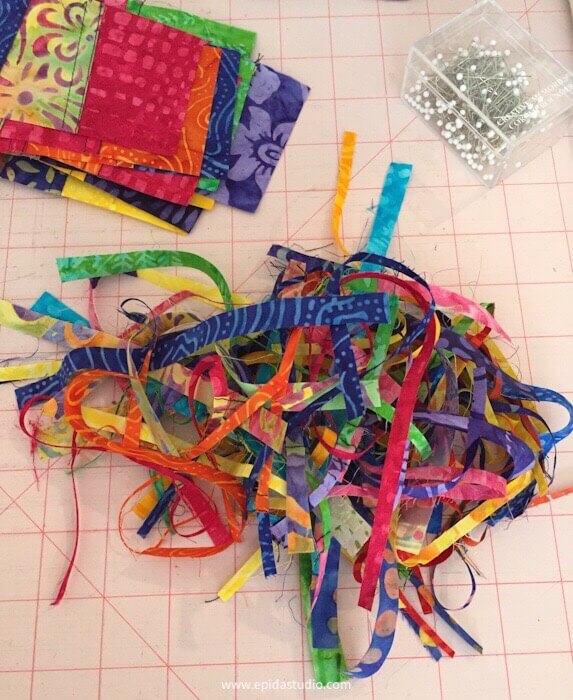 pile of tiny fabric scraps with pins