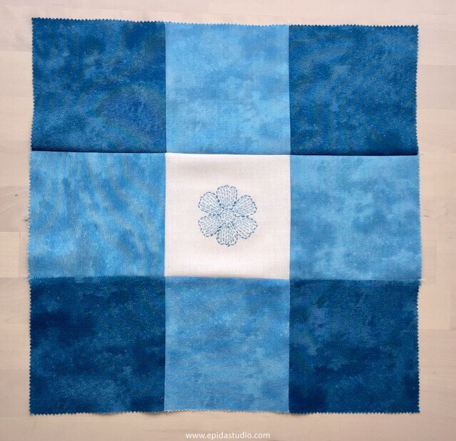 blue nine patch with flower embroidered in the centre