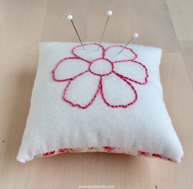 pincushion with pink embroidered flower