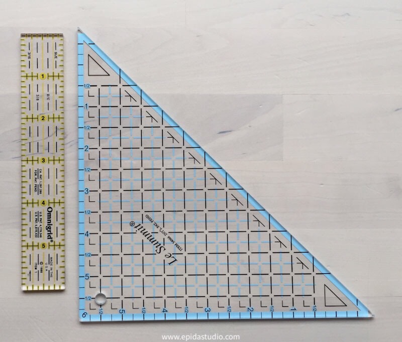 a straight ruler beside a triangle ruler.
