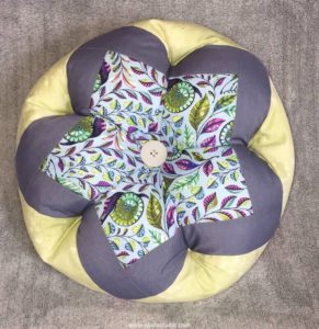 decorative pillow in the shape of a flower