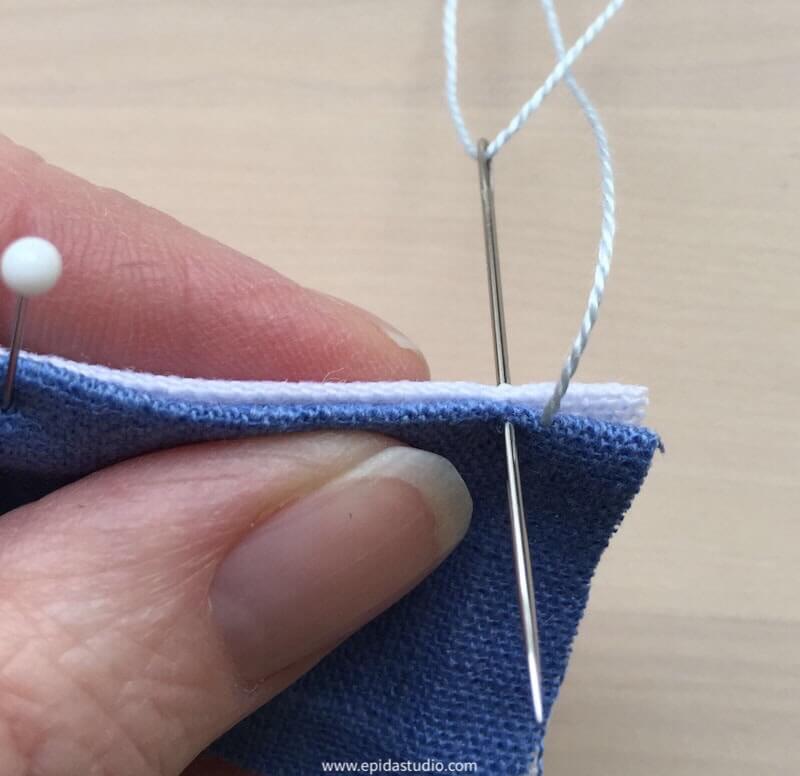 stitching a pojagi seam to join white and blue linen