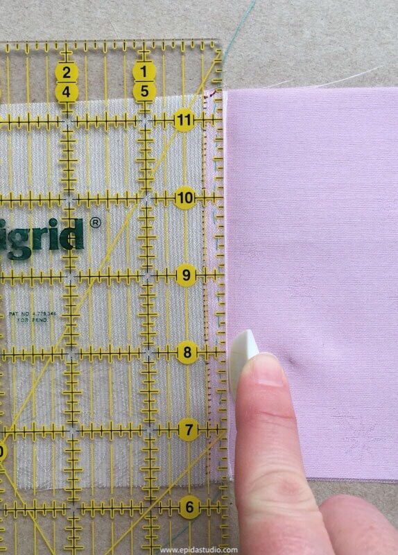 creasing pink fabric with a hera marker