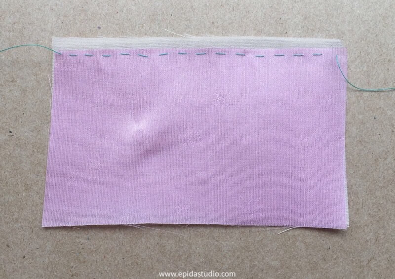 pink and white fabric basted together