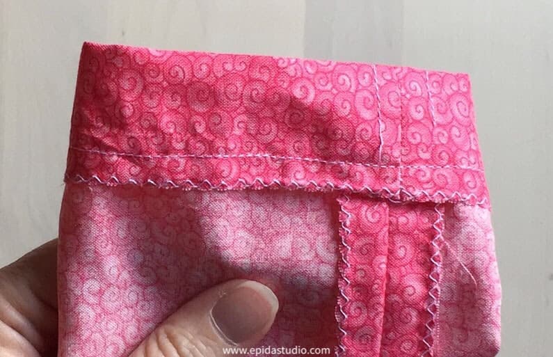 hemming the bag to form the drawstring channel.