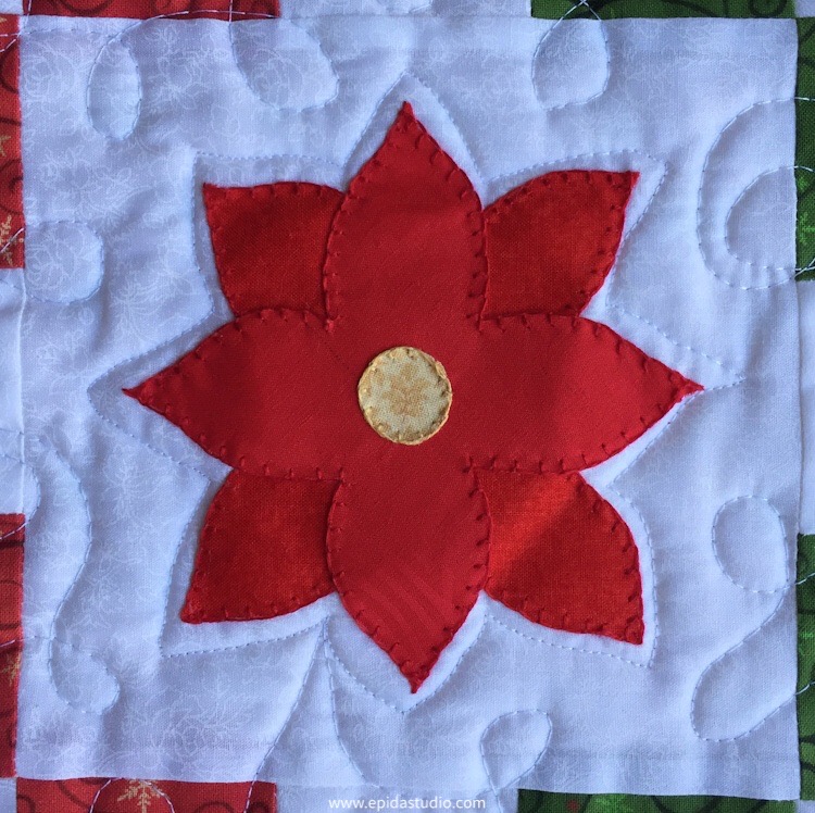 poinsettia applique with blanket stitch embroidery embellishment.