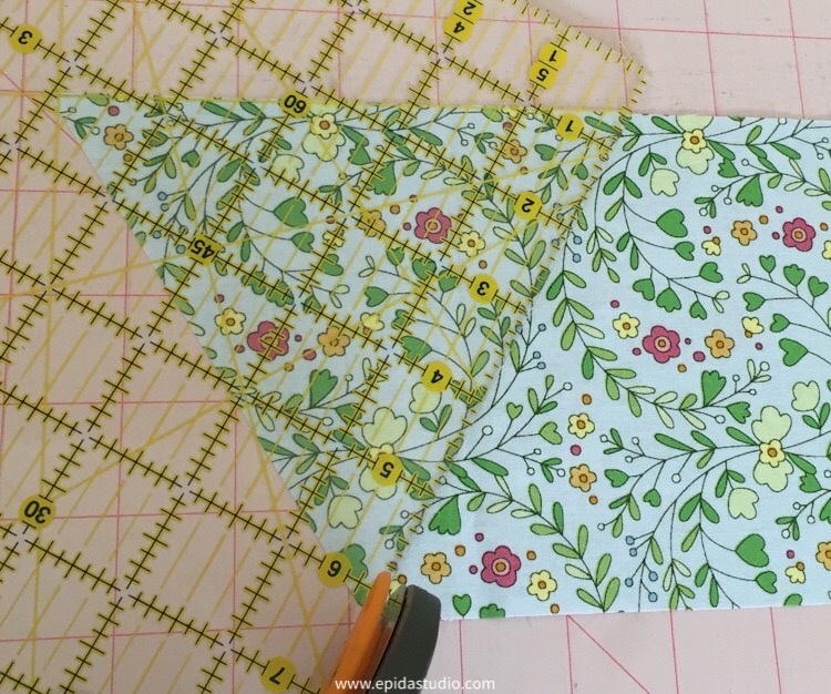 second cut for an equilateral triangle from a strip of fabric.