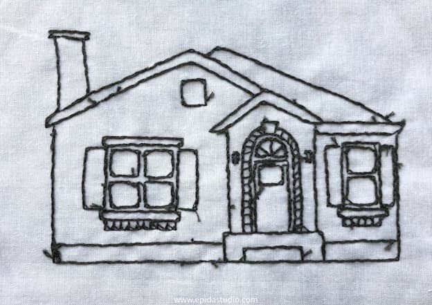 reverse side of backstitch house embroidery.