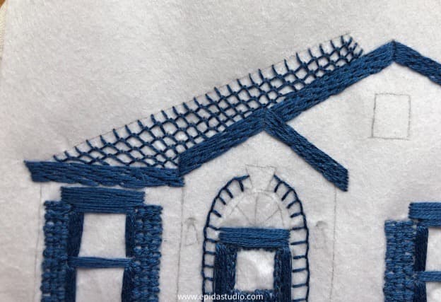 close up of feather stitch roof on embroidered house.