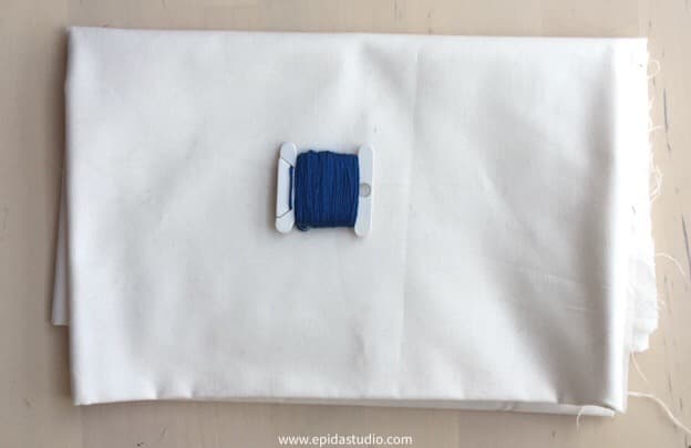 white cotton fabric with blue floss