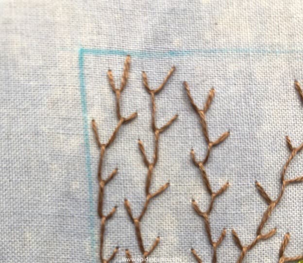 close up of feather stitched branches