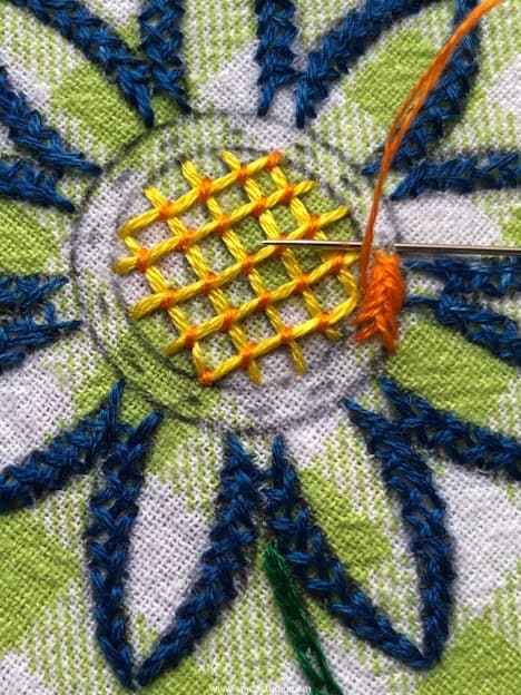 stitching an outline with cross stitch.