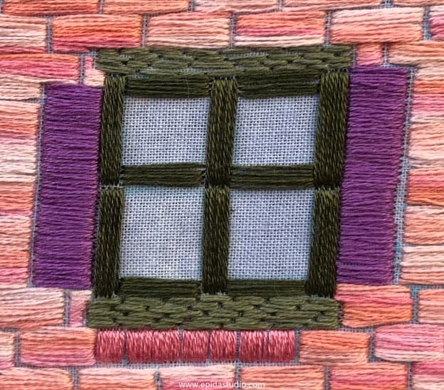 close up of window embroidered with satin stitch.