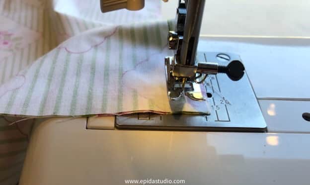 lifting the presser foot to turn the corner.