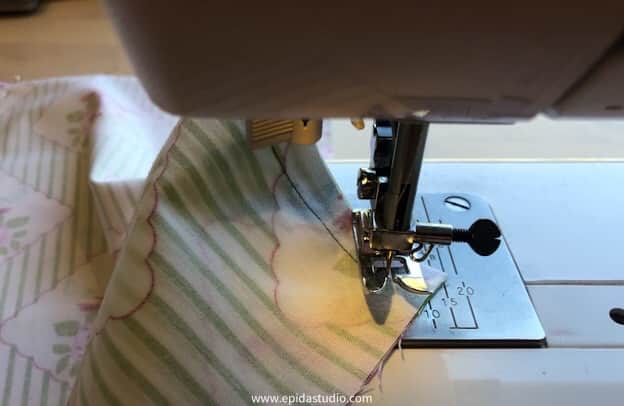 turning the fabric to sew a corner.