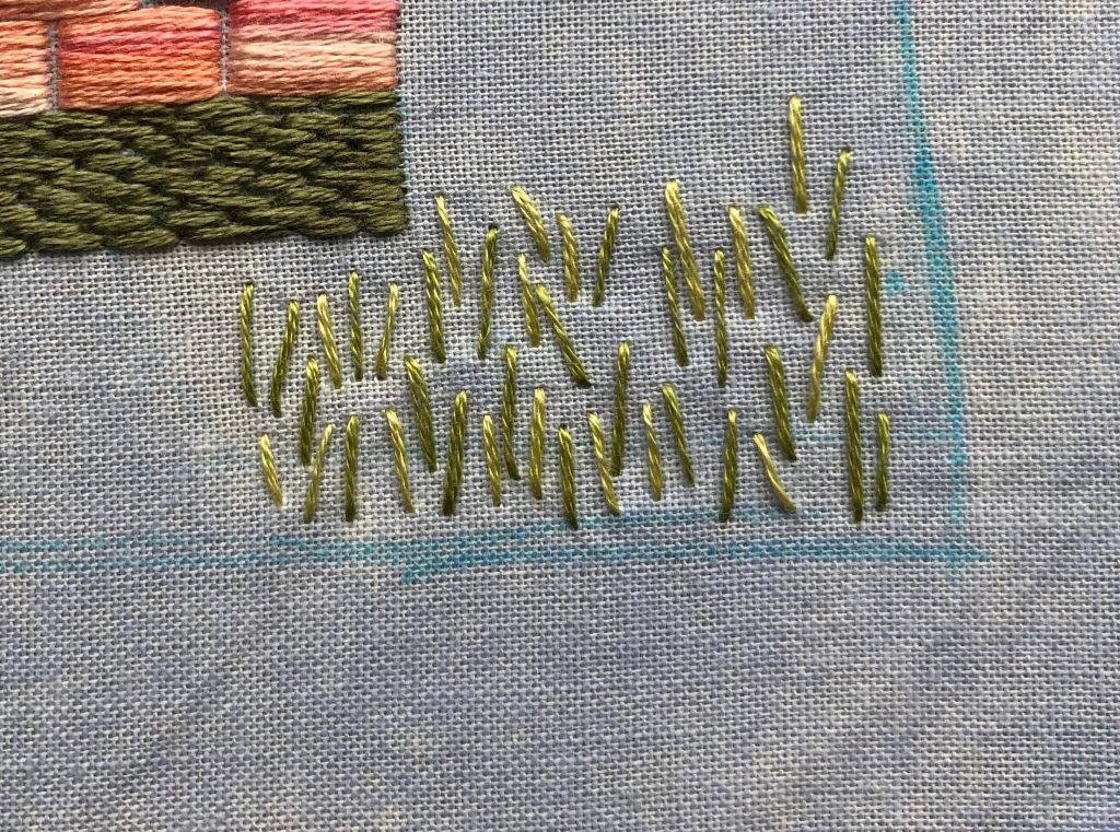 flower stems stitched in two shades of green.