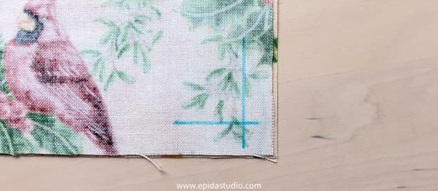 wrong side of fabric with corner marked.