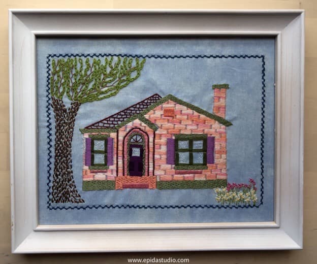 house embroidery in white frame.