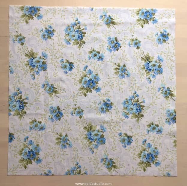 square of white and blue floral fabric.