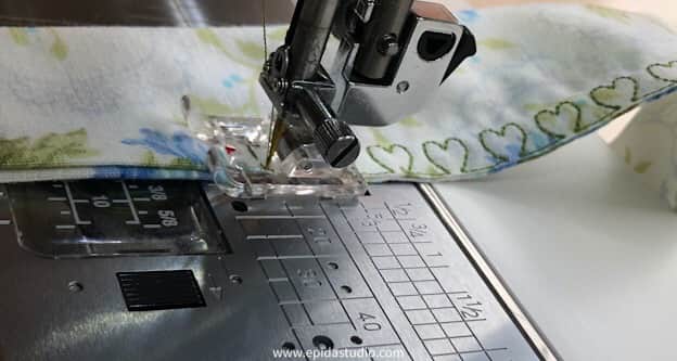 sewing machine doing decorative stitching on apron tie.