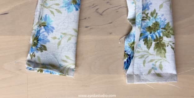 stitching the ends of the apron tie.
