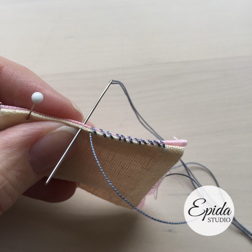 hand stitching a traditional pojagi seam.