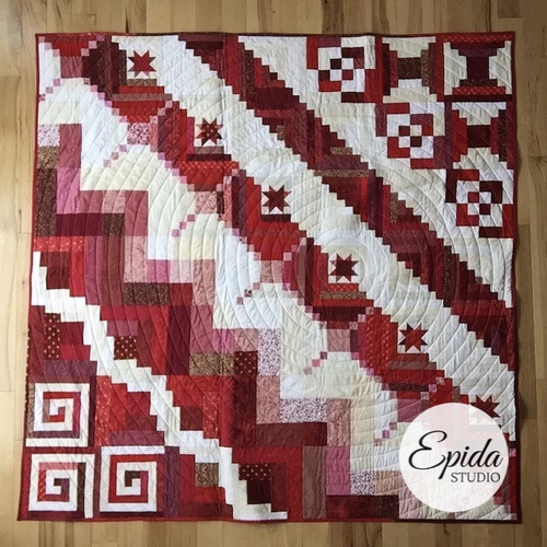 red and white log cabin sampler quilt.